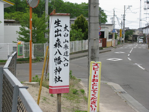 人来田小学校の前にある生出八幡神社へ行く方角を示す看板
